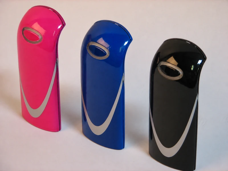 Three handheld product forms in pink, blue, and black finishes.