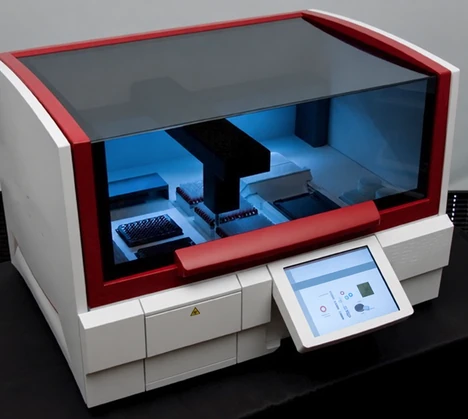 An enclosed laboratory platform with a visible internal workspace and an external touchscreen.