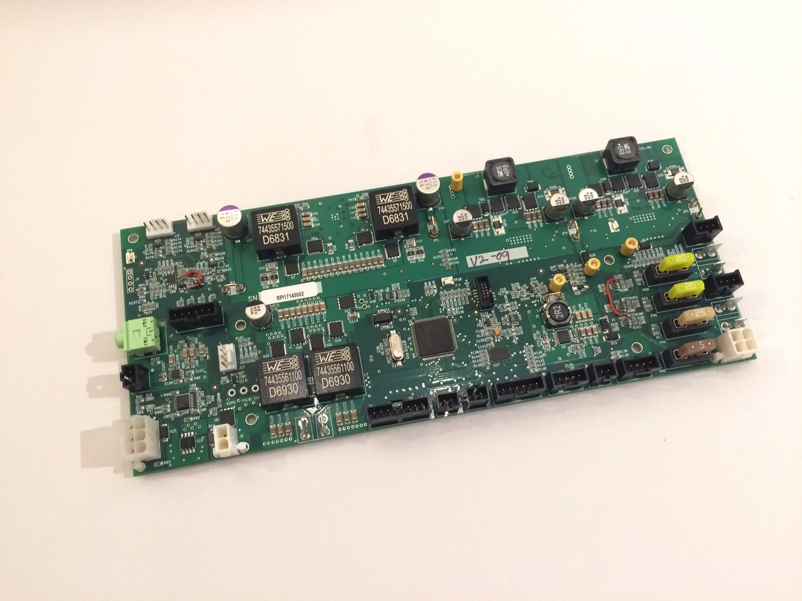 A green control circuit board with power components, connectors and a microcontroller.